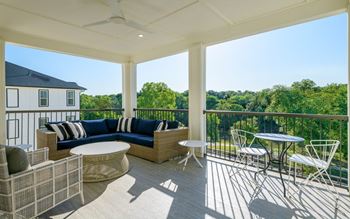 Covered porch with furniture and a table and chairs